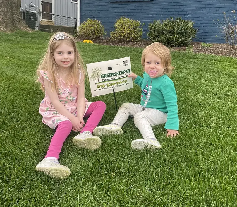 Greenskeeper kids in grass