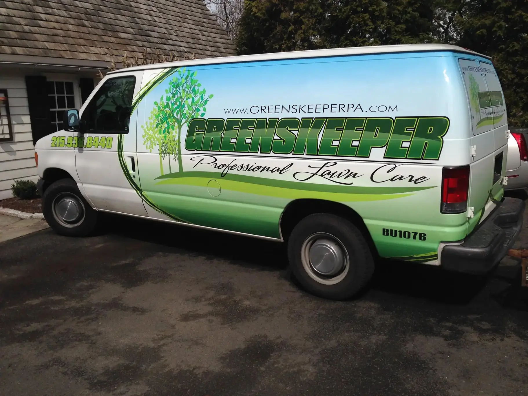Greenskeeper van outside of house