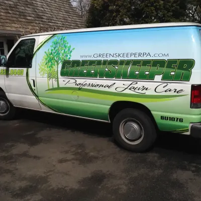 Greenskeeper van outside of house