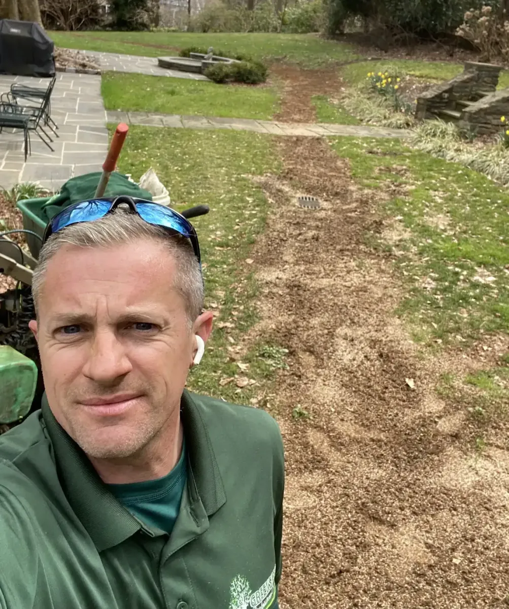 Greenskeeper owner working on lawn drainage installations