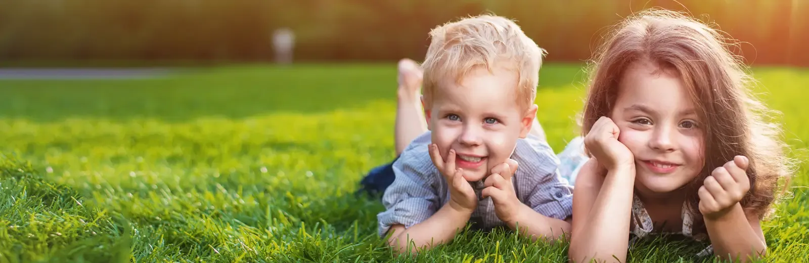 kids laying on thick healthy green grass