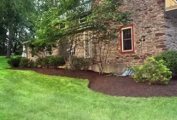 brick house with a mulch flower bed