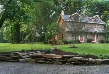 rock wall in front of the house